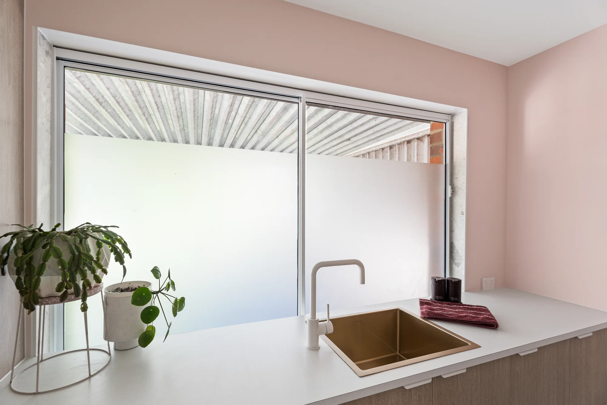 Pink laundry and timber cabinetry completed by Ivory Built in Reservoir