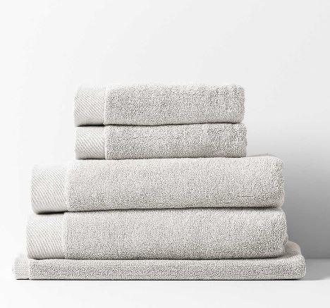 Stack of Aura Home Haven towels in dove grey with a soft looped texture